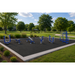 Outdoor fitness equipment on a black rubber pad in a park setting with green grass, trees, and a blue sky.